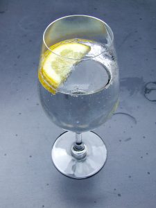 A glass of water with some lemon, to go with your coffee.